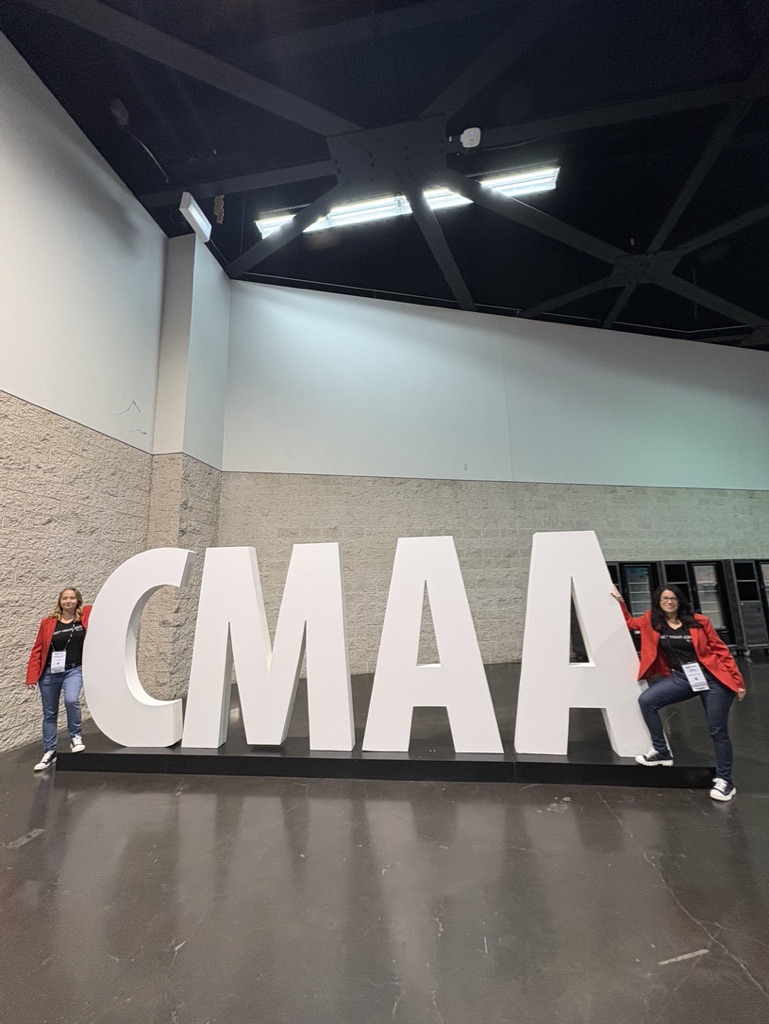 NxtEdge team members with the giant CMAA letters at the World Conference & Club Business Expo