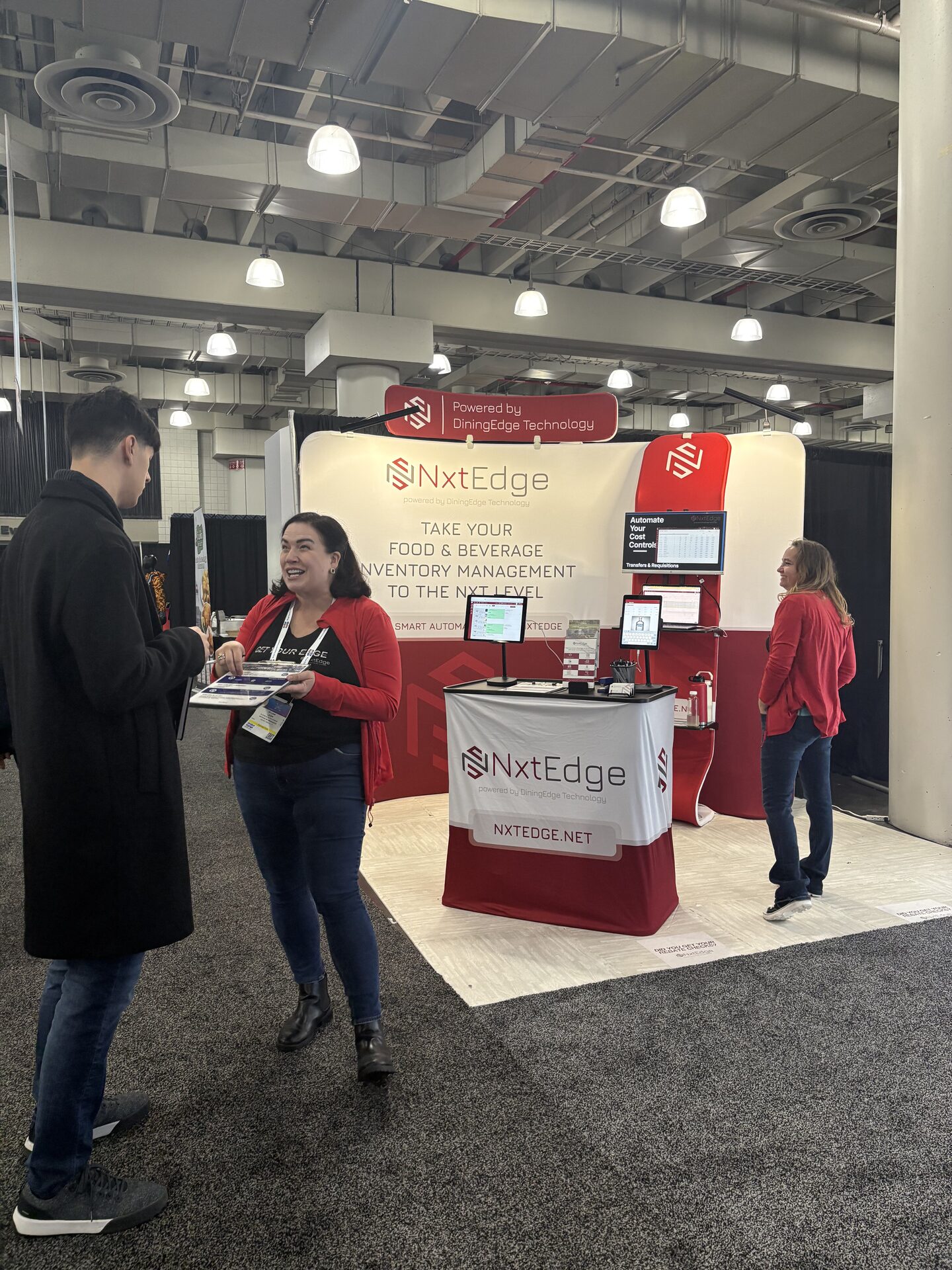 NxtEdge team member speaking with an attendee at the New York Restaurant Show booth